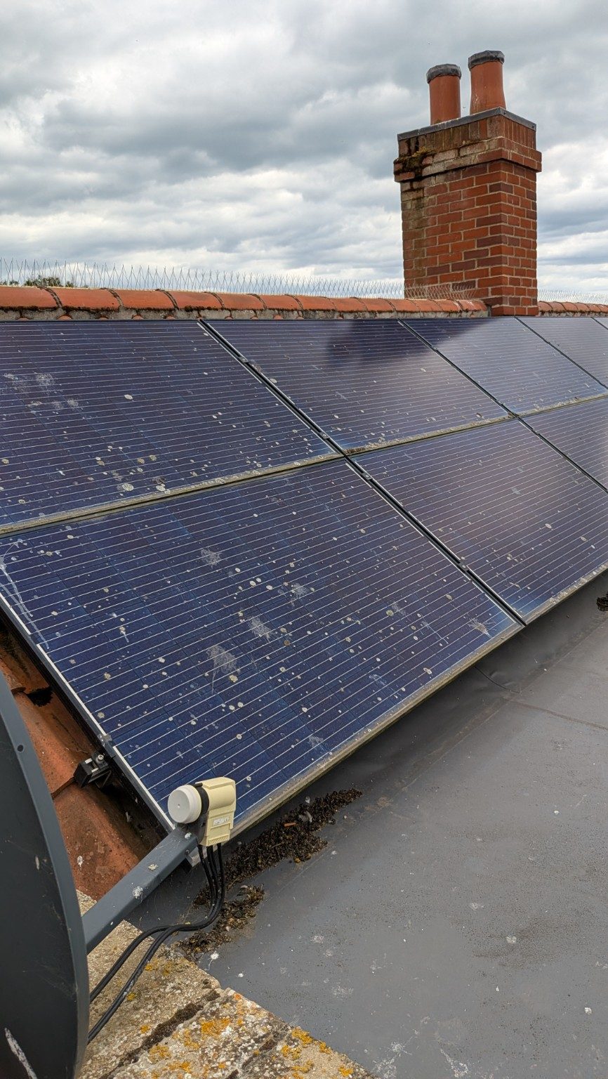 Dirty solar panels with bird mess and debris before cleaning in Southwold